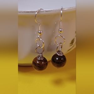 A pair of Tiger eye earrings.